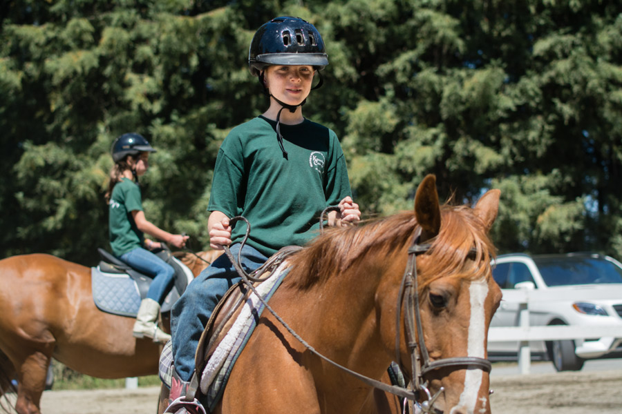 Child riding horse photo