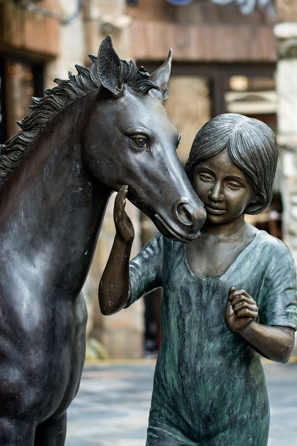 Girl and horse sculpture photo