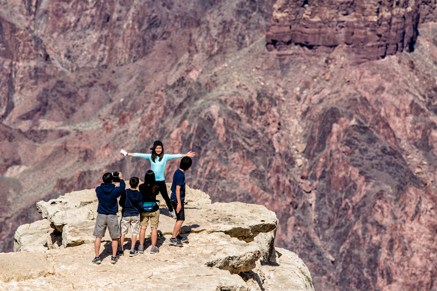 Asian family photographing girl at Grand Canyon photo