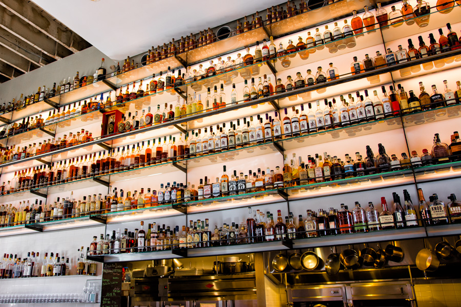 Whiskey bottles on bar wall photo