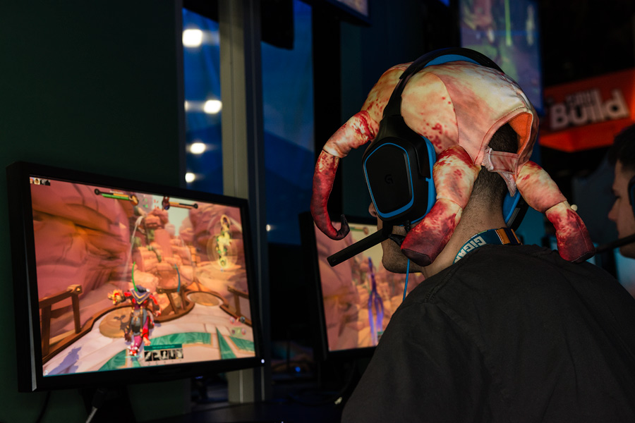 Guy with crab hat playing games at PAX South 2015 Photo
